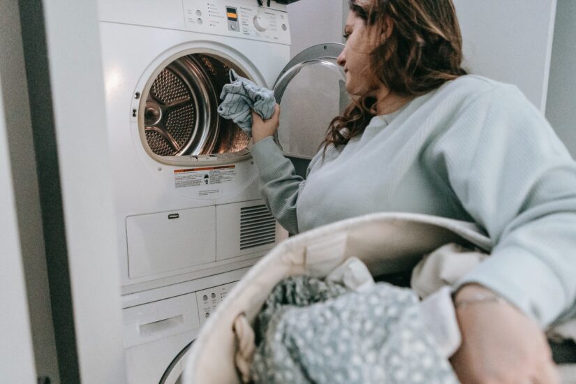 woman loading clothes in the washing machine